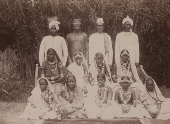 Indentured men and women posing in front of a canefield in Guyana